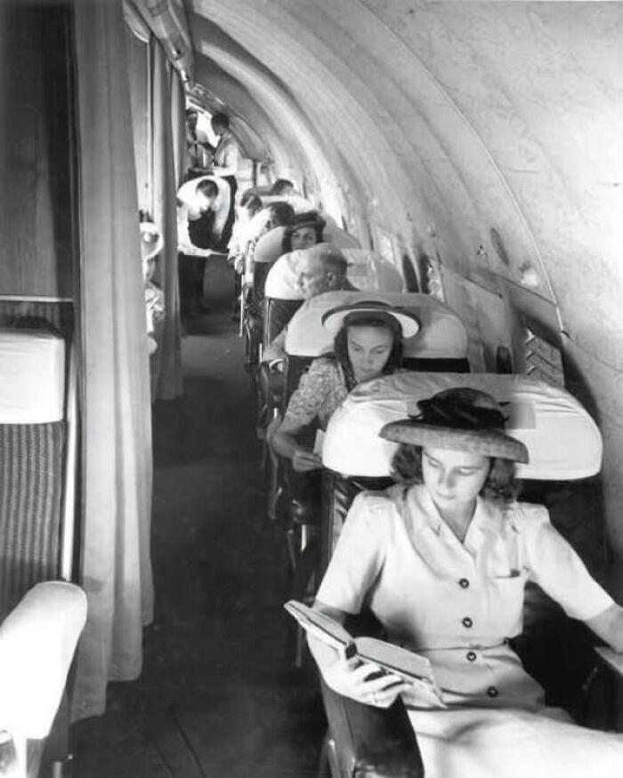 Passengers seated inside a commercial airplane cabin in old photos of America