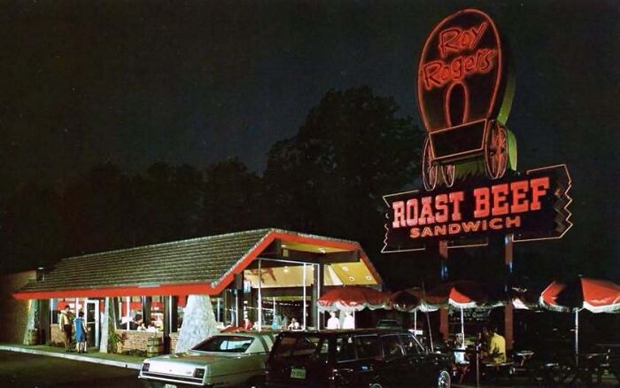 Neon sign of Roy Rogers restaurant at night captured in old photos of America.