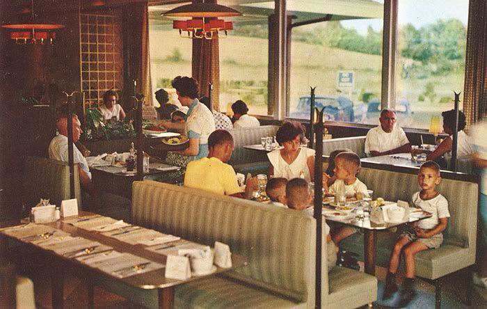 Families dining inside a vintage mid-century restaurant in one of these old photos of America.