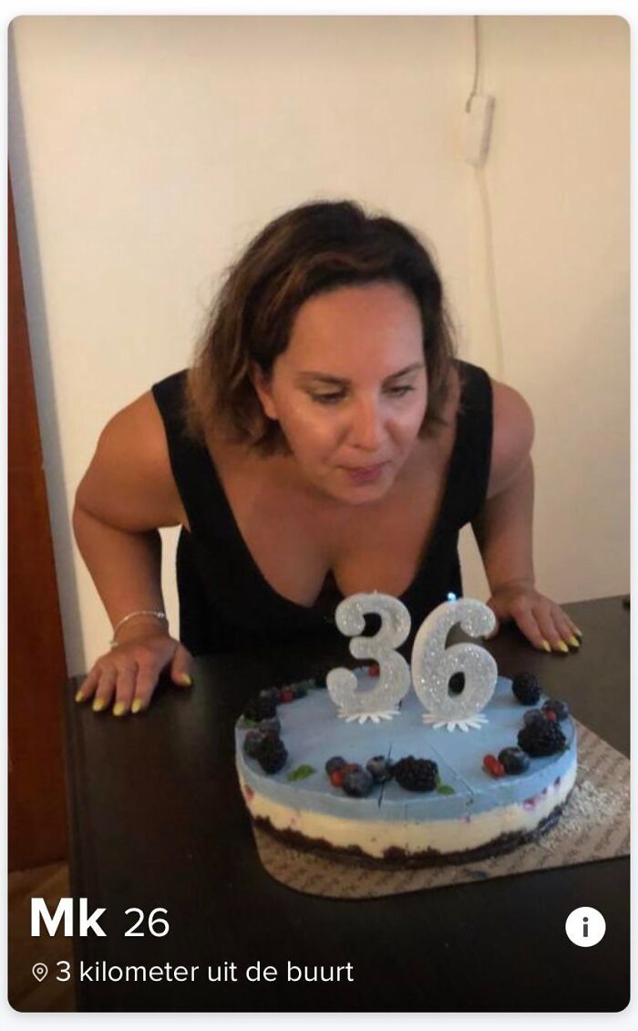 Tinder stories screenshot of a woman blowing out birthday candles on a 36 cake while her age says 26