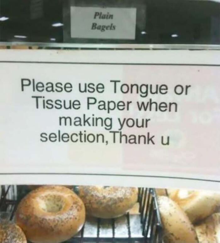 A store sign with a funny typo instructing customers to use tongue instead of tongs, showing someone confidently wrong.