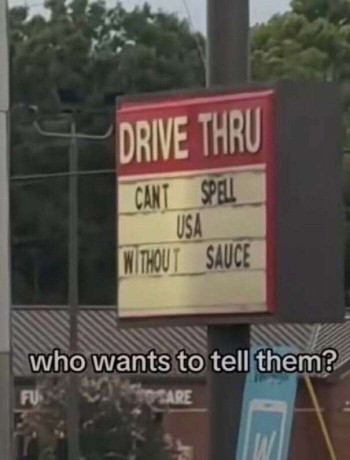 A drive-thru sign with a typo reading Cant spell USA without sauce, an example of being confidently wrong.