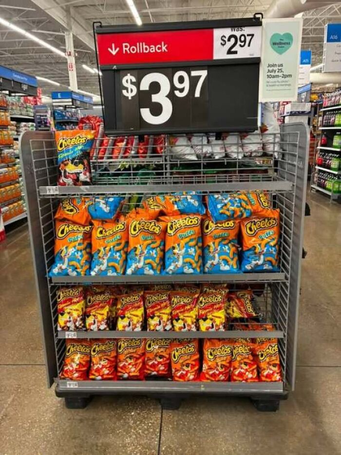 Store display sign with a rollback price higher than the original price, showing people confidently wrong.