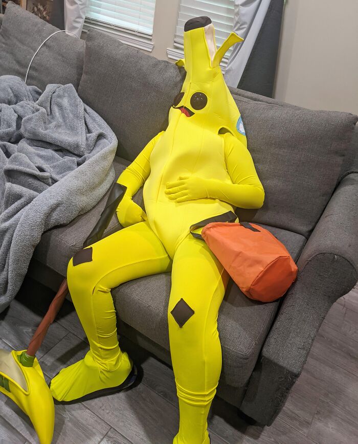 Person slumping on a sofa in a banana costume when Halloween didn't go as planned.