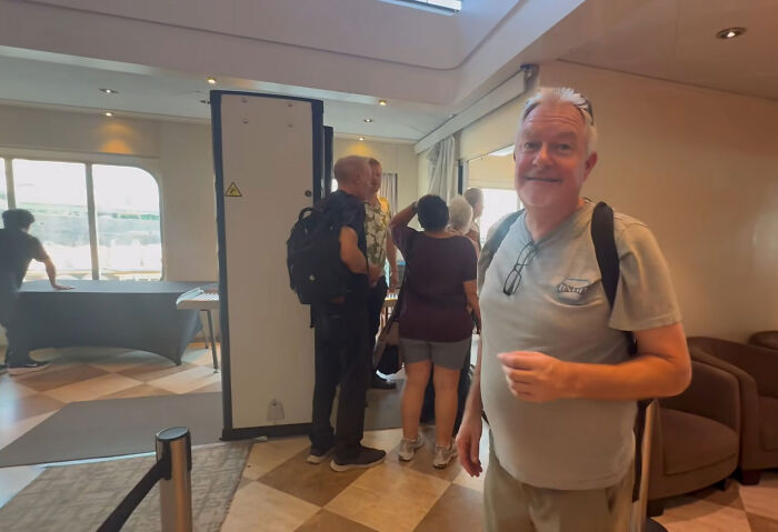 Guests queuing inside a permanent cruise ship terminal area Guests queuing inside a permanent cruise ship terminal area