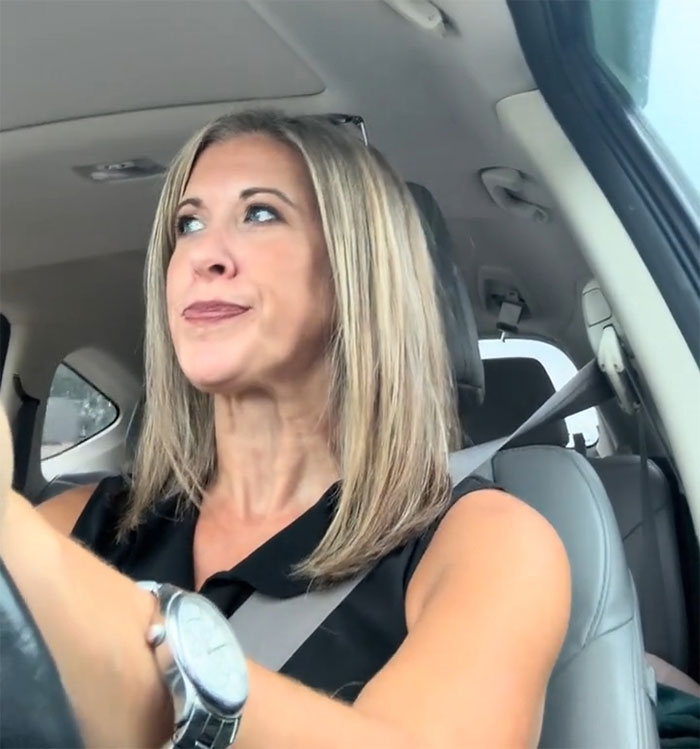 A blonde woman driving a car, reflecting on her experience after becoming a tradwife. A blonde woman driving a car, reflecting on her experience after becoming a tradwife.