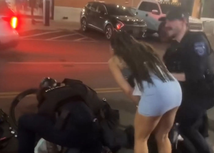 Arizona State Cheerleader being restrained by police officers during an arrest