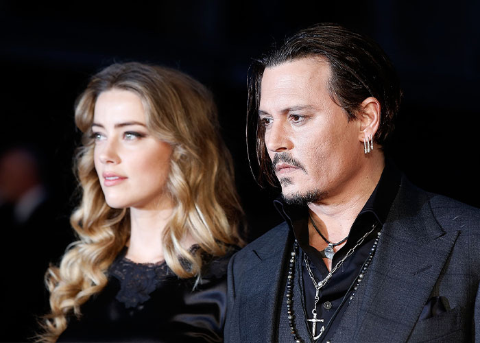Johnny Depp standing next to Amber Heard at an event