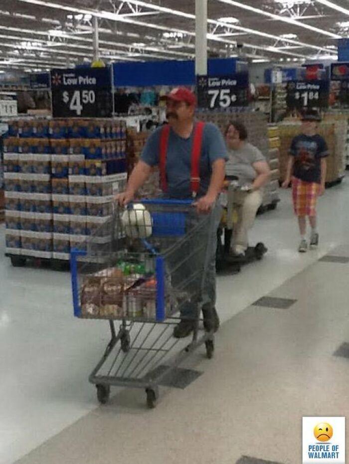 Man pushing shopping cart at Walmart wearing red suspender and cap