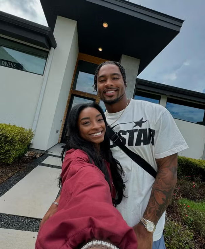 Simone Biles taking a selfie with husband Jonathan Owens outside their 1.2M Texas home