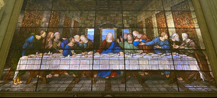 Stained glass window depicting the Last Supper scene with multiple figures Stained glass window depicting the Last Supper scene with multiple figures