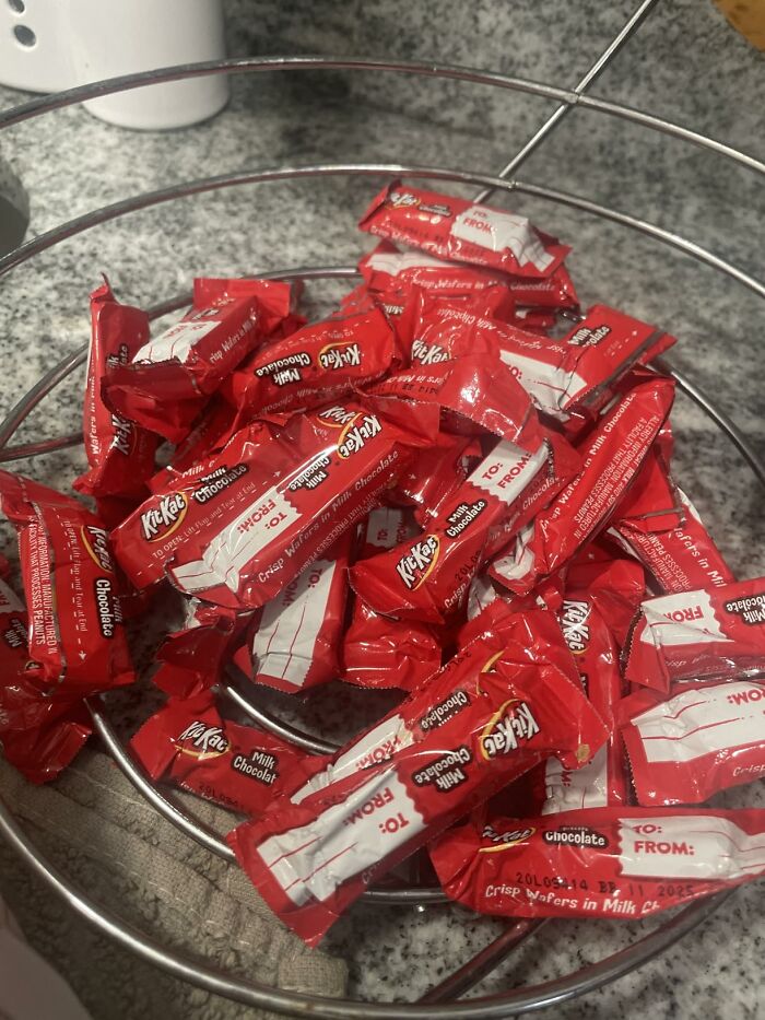 A metal basket filled with individually wrapped mini Kit Kat chocolate bars for Halloween Candies