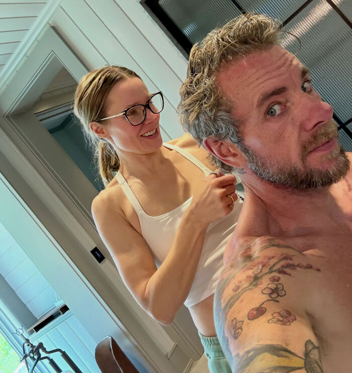 Kristen Bell wearing glasses beside her husband Dax Shepard