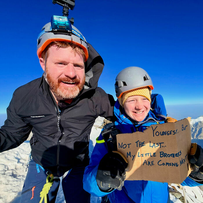 Smiling dad and his 7-year-old son celebrating after climbing Yosemite's El Capitan