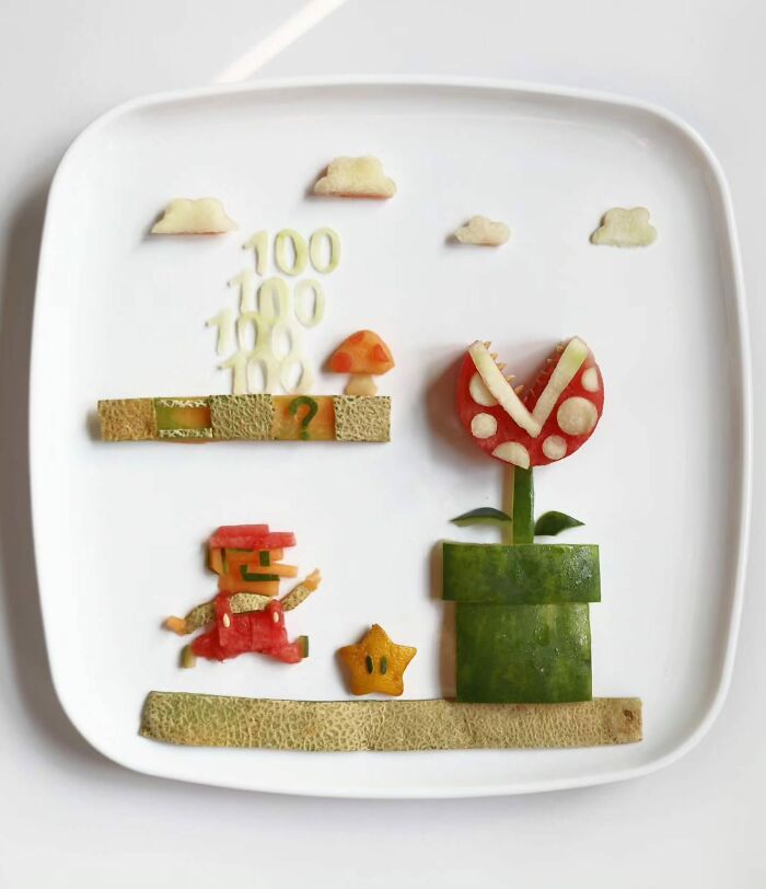 Sarah Rosado food art recreating a classic video game scene with Mario, a star, and a plant using cut melons.