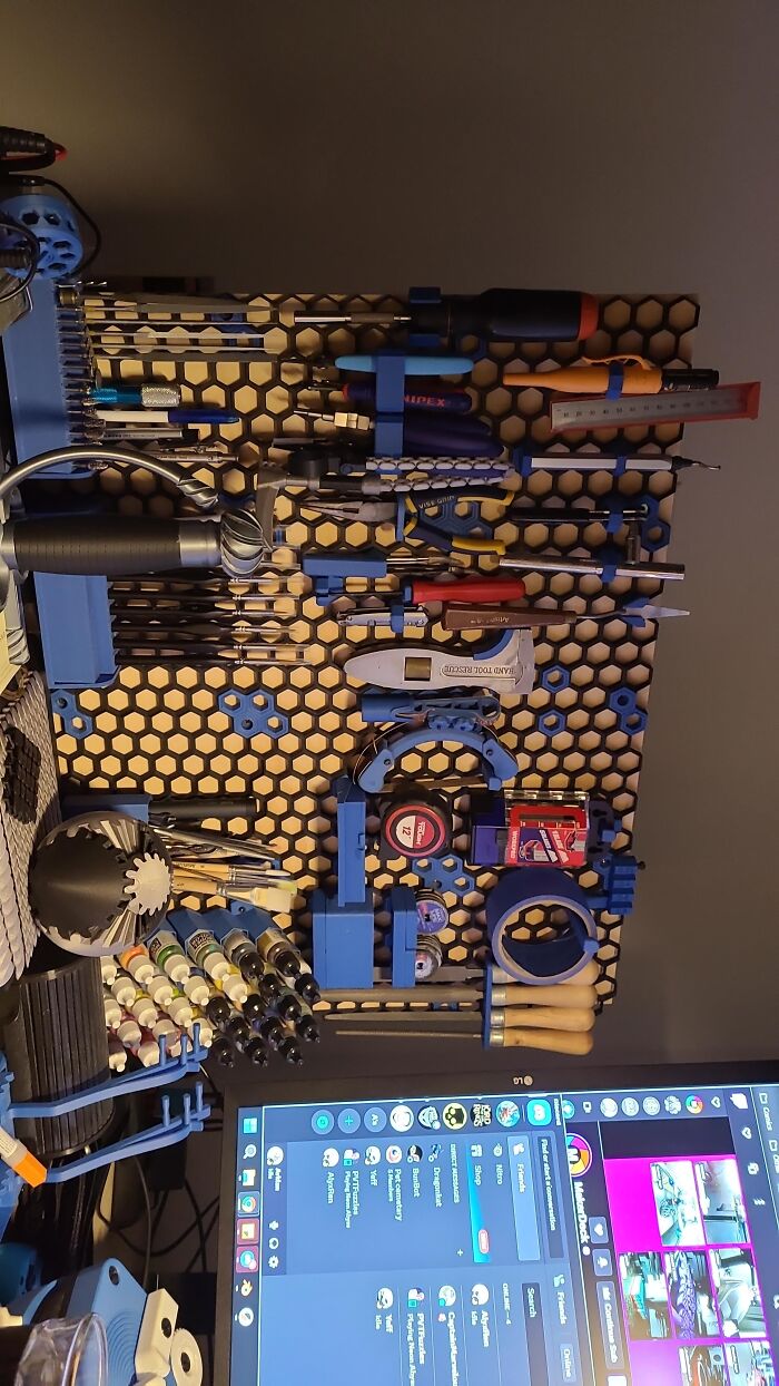 Organized workshop board with blue 3D prints utilized as custom tool holders.
