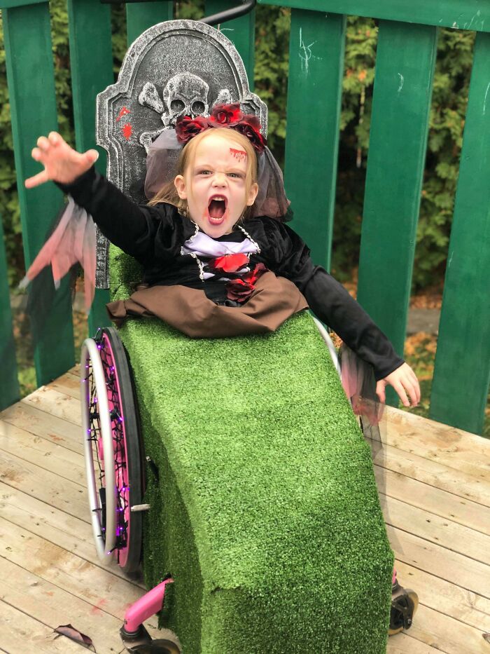 Young girl in a graveyard wheelchair costume, showing how people with disabilities won Halloween.