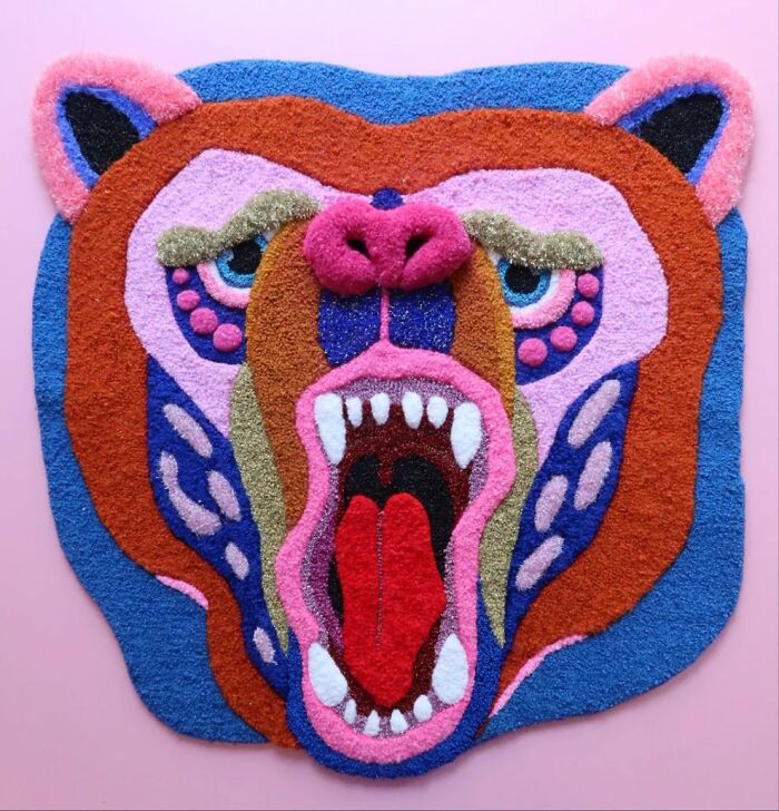 Vibrant tufted rug of a roaring bear face by Ina Dyreborg