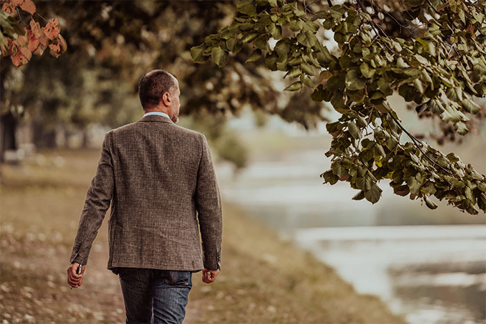 Back view of a man walking away outdoors, illustrating a former tradwife left alone. Back view of a man walking away outdoors, illustrating a former tradwife left alone.