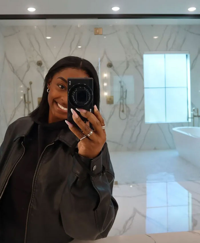 Simone Biles taking a mirror selfie inside her luxury Texas home bathroom
