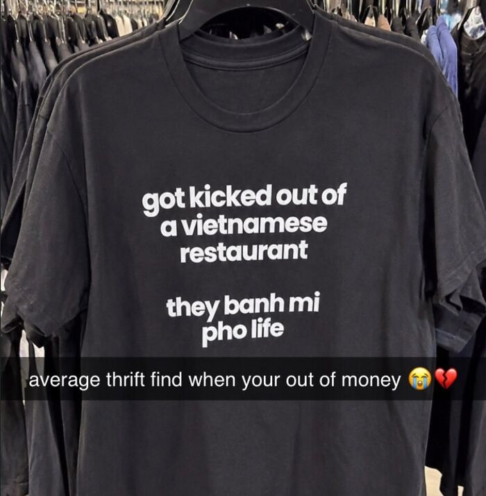 Black T-shirt with funny Vietnamese restaurant pun quote on display