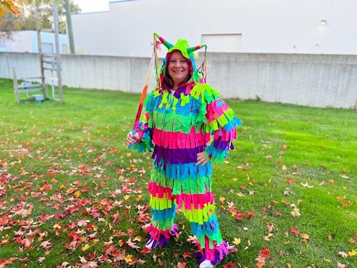 A person standing outdoors in a colorful piñata suit as a fun low-effort Halloween costume.