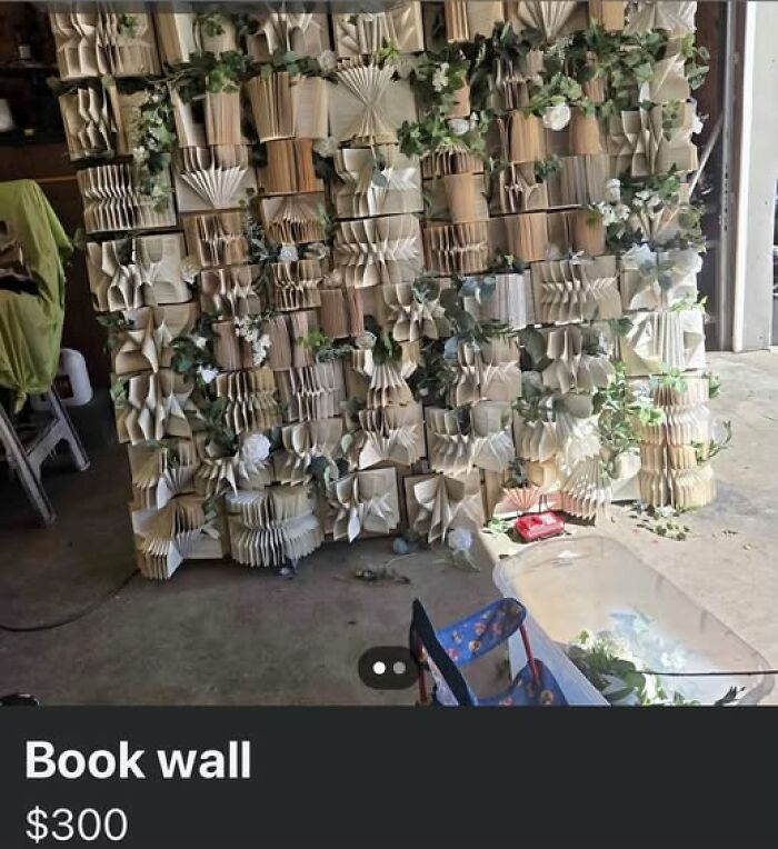 A DIY book wall display made from folded pages of old books as hilariously shame worthy art projects