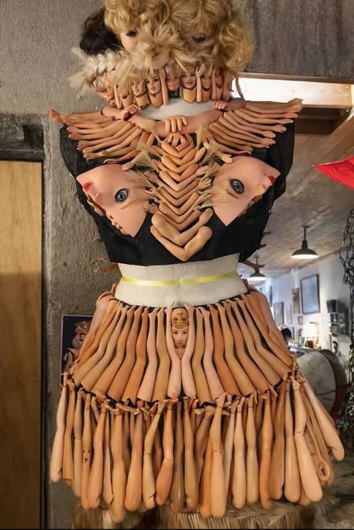 Creepy art projects featuring a dress form covered in Barbie doll heads, arms, and legs.