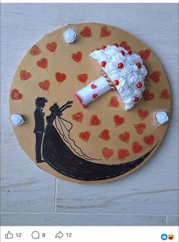 A handmade wedding-themed art project featuring a 3D white rose bouquet and a silhouette of a couple.
