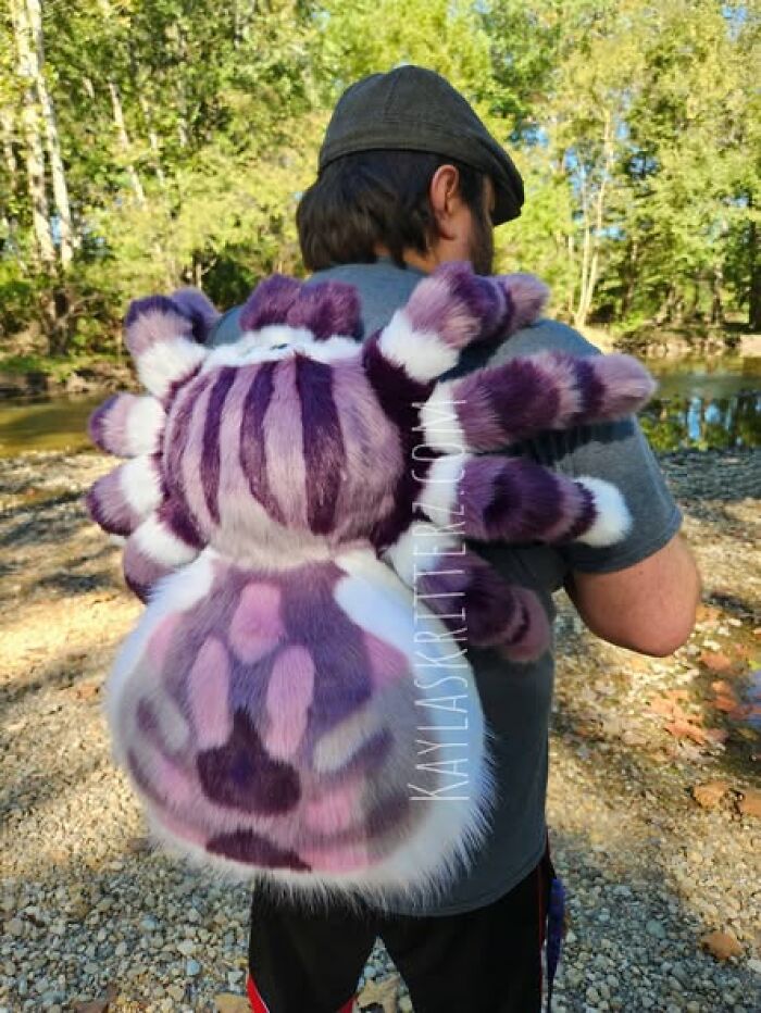 A giant, furry purple spider backpack worn by a man, showing hilarious crafts and art projects.