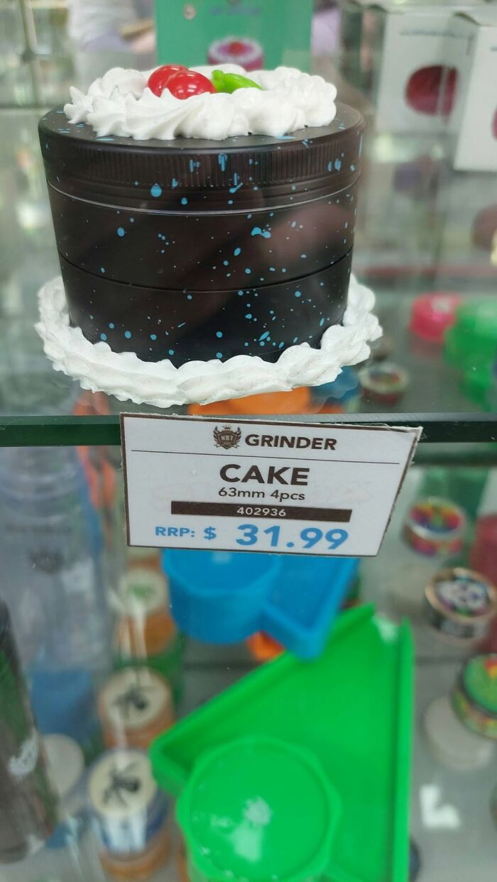 A unique cake-shaped herb grinder on a glass shelf, part of hilarious crafts and art projects