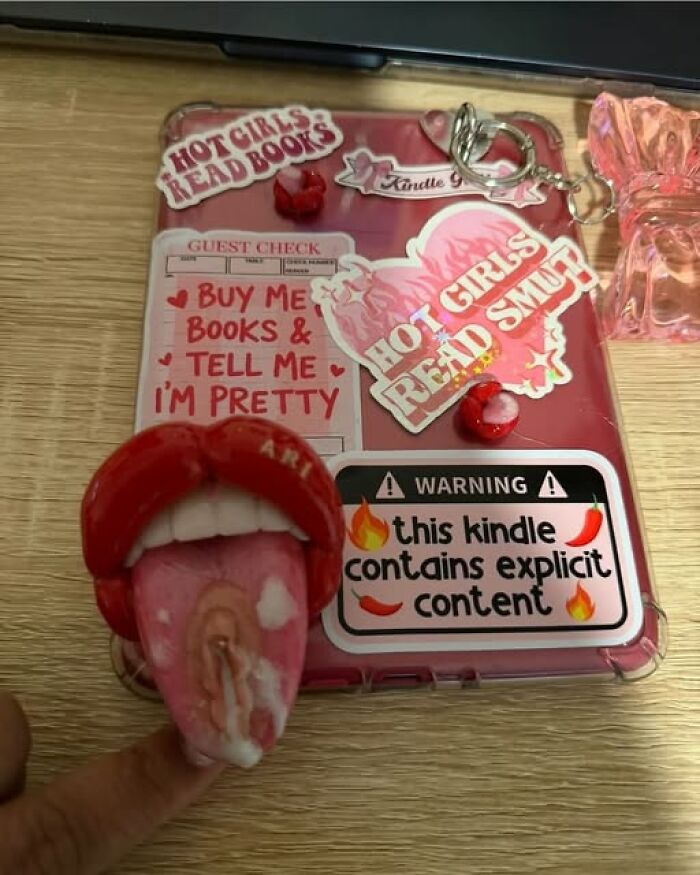 Funny art projects of a decorated pink Kindle case with stickers and an adult themed phone grip