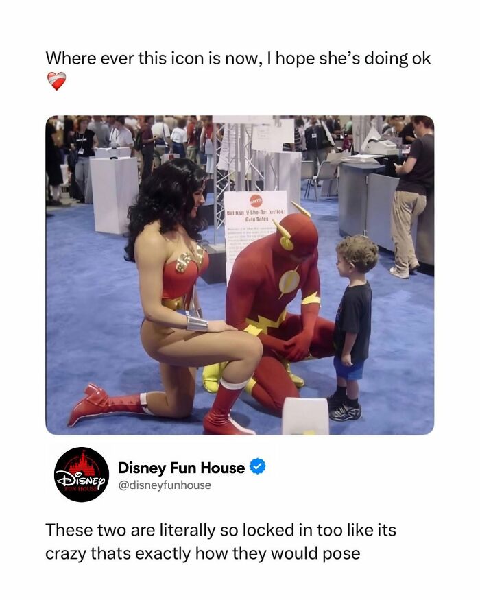 Cosplayers of Flash and Wonder Woman talking to a young child at a pop culture event