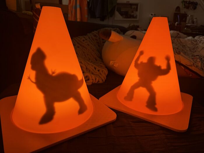 Two orange cones illuminated with Toy Story shadows made via 3D printer