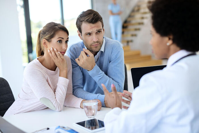 Couple upset during medical consultation with doctor in clinical setting