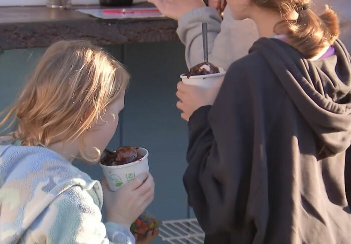 Young customers enjoying delicious treats from a supportive ice cream shop owner. Young customers enjoying delicious treats from a supportive ice cream shop owner.