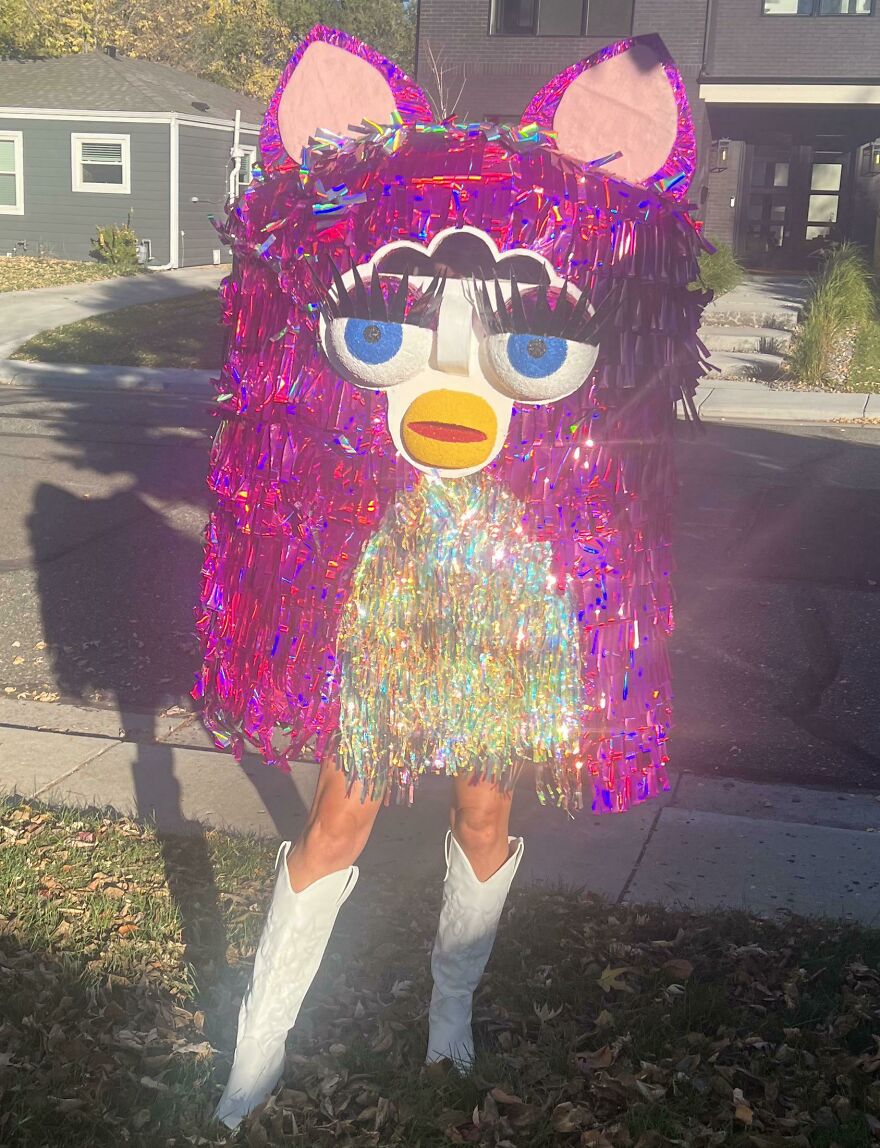 Person wearing a giant sparkly pink Furby costume outdoors as a creative Halloween costume idea.