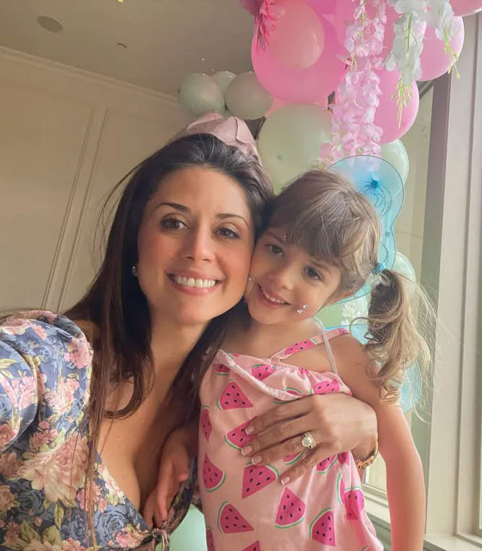A smiling mother hugging her young daughter, relevant to the custody battle case A smiling mother hugging her young daughter, relevant to the custody battle case
