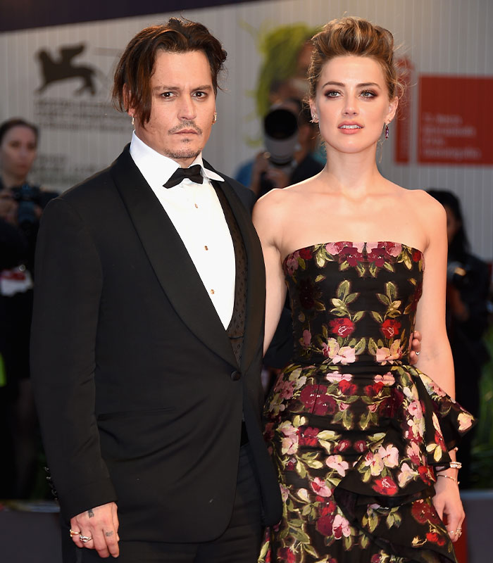 Johnny Depp and Amber Heard posing in formal attire