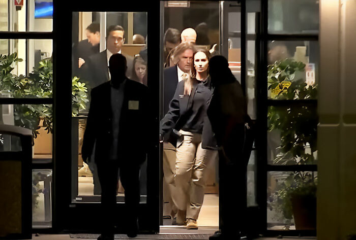 A group of people walking through glass doors, discussing Christa Pike lethal injection case