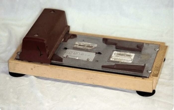 An old-school vintage manual credit card imprinter machine familiar to 80s kids.