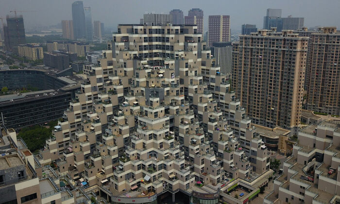 Strange stepped pyramid residential building in urban cityscape