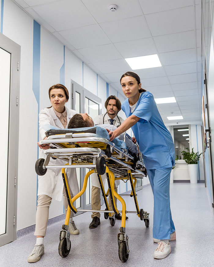 Medical team rushing a patient on a stretcher to the ICU.