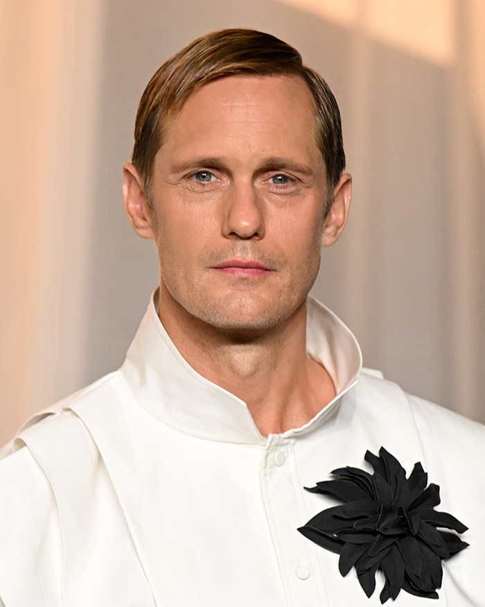 Unedited photo of Alexander Skarsgard wearing a white outfit at the Academy Museum Gala.