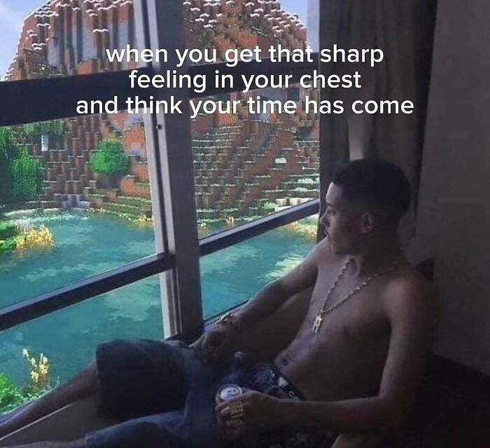 A man sitting by a window looking at a Minecraft landscape representing dark humor memes.