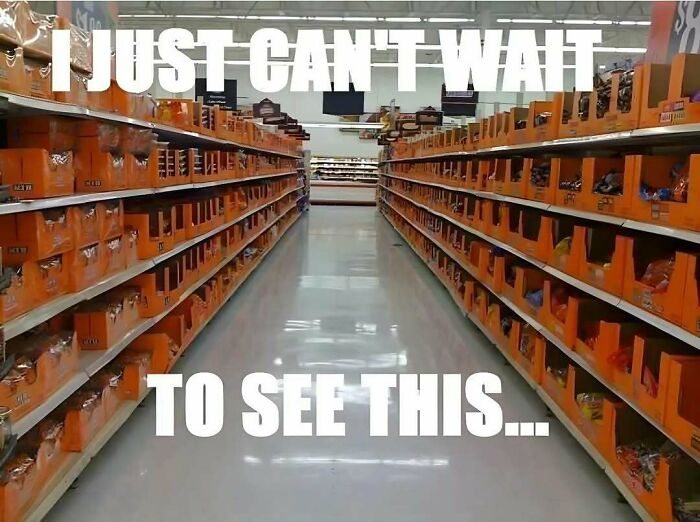 Spooky season meme showing a grocery store aisle filled with orange Halloween candy boxes.