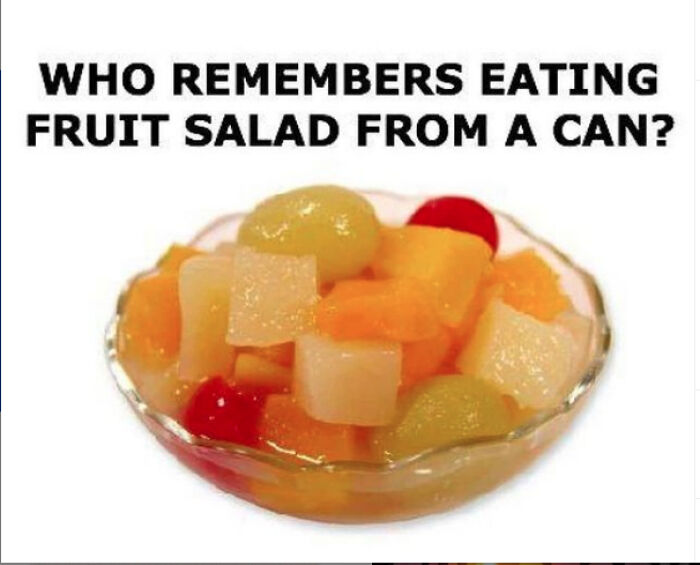 A bowl of canned fruit salad with cherries, peaches, and pears, bringing back nostalgic dessert memories.