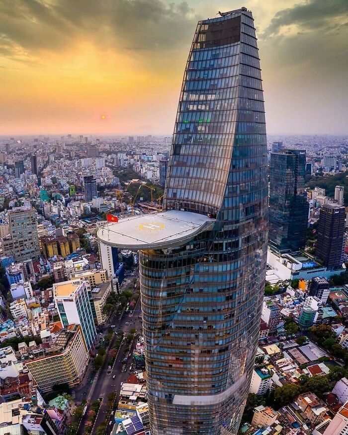 Twisting skyscraper with helipad at sunset strange buildings