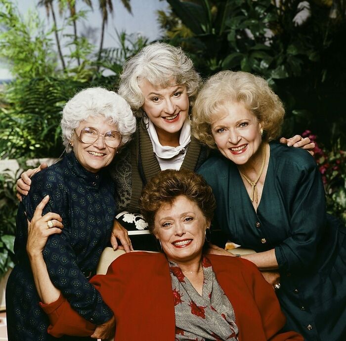 The cast of The Golden Girls smiling together in a nostalgic photo