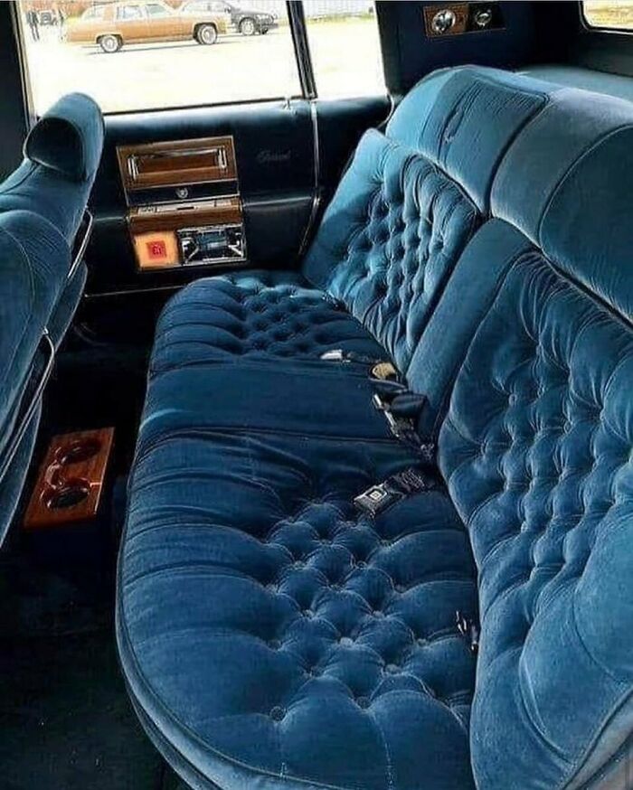 Nostalgic retro blue velvet tufted interior of a classic luxury car